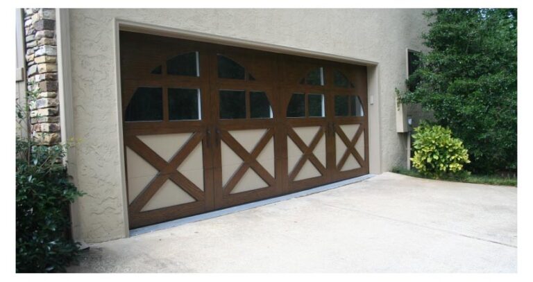 Picture of a tan house with a brown garage door.