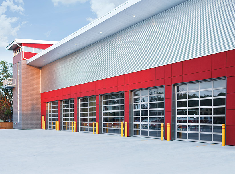 Picture of a red and silver fire station with see though doors.